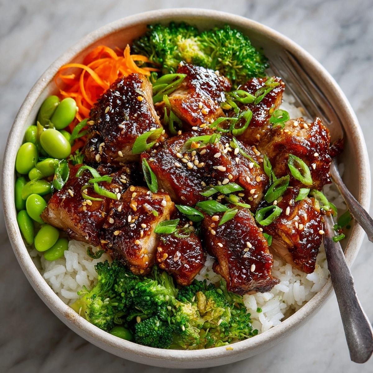 Chicken Teriyaki Rice Bowl with glistening sauce, featuring tender chicken and fluffy rice.