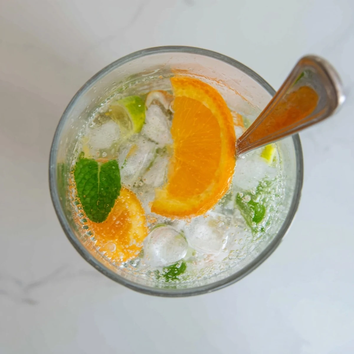 Refreshing probiotic soda mocktail with citrus and mint, perfect for summer enjoyment.  