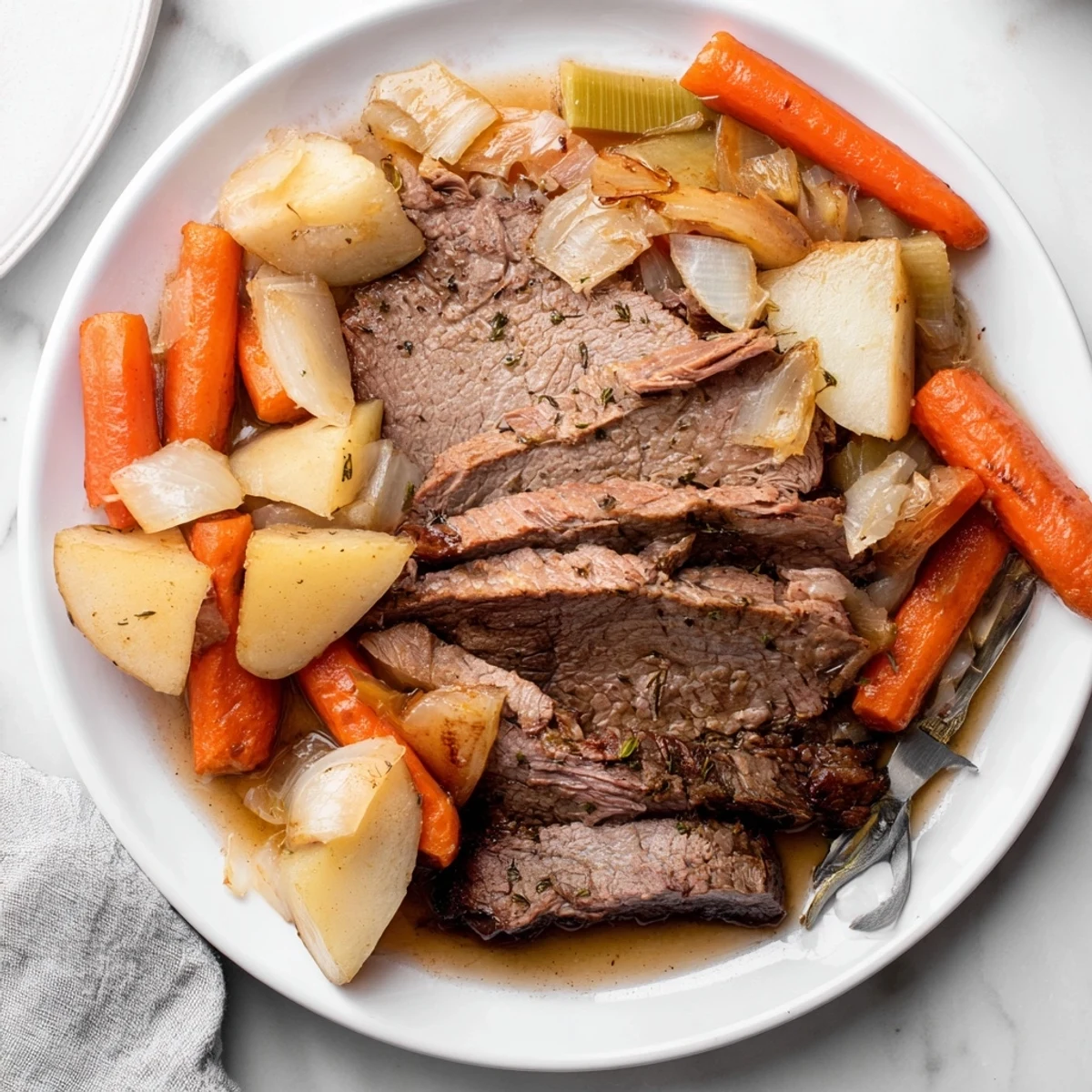 Juicy Sunday Pot Roast with roasted vegetables served on a rustic platter.  