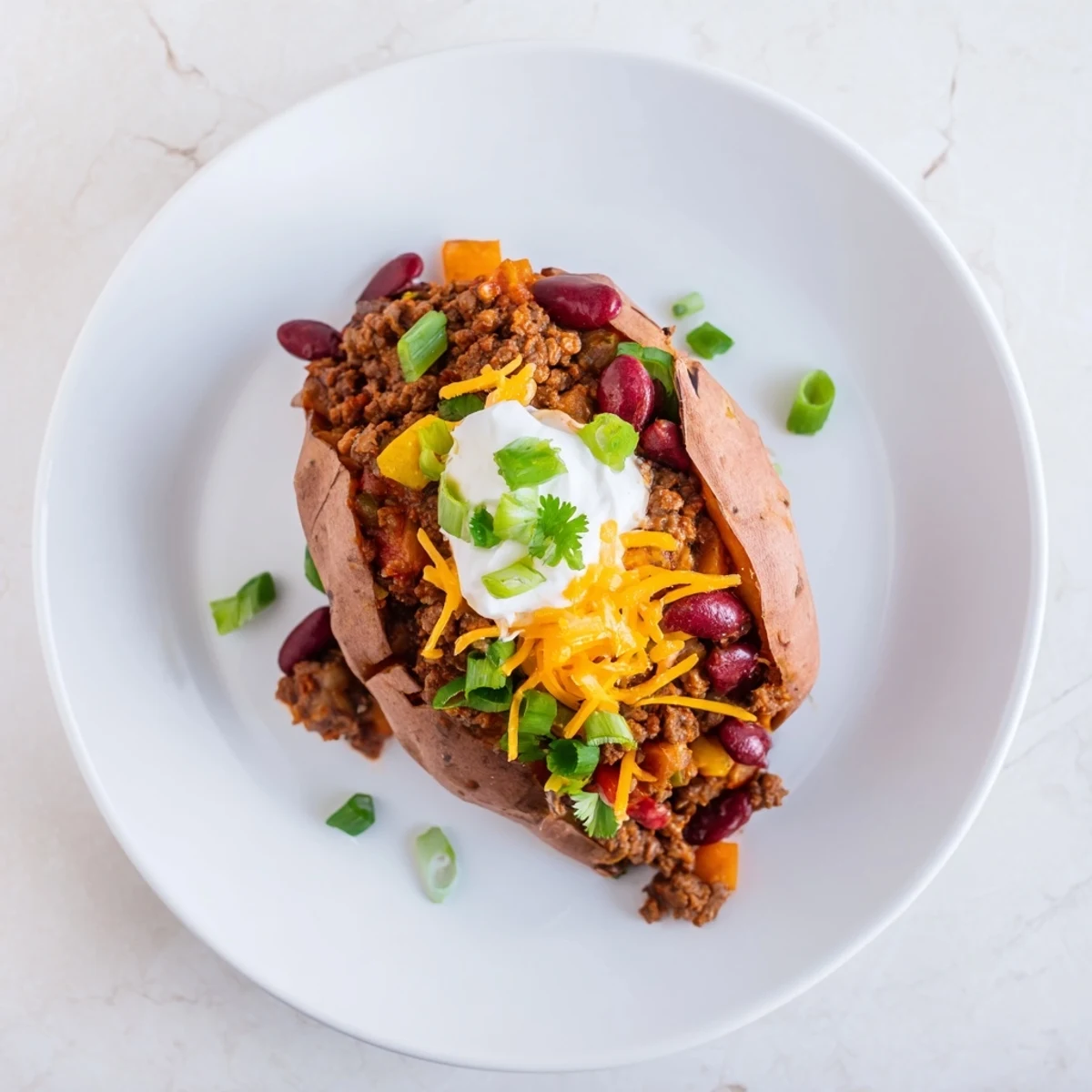 Baked Sweet Potato Stuffed with Chili, a delicious meal with a steaming, savory chili filling.