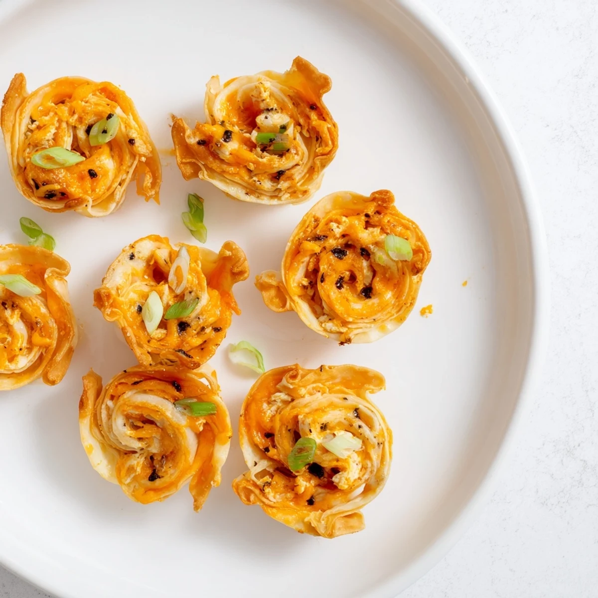 Crispy Buffalo Chicken Dip Pinwheel Wontons: a delicious appetizer bursting with savory, spicy flavors.