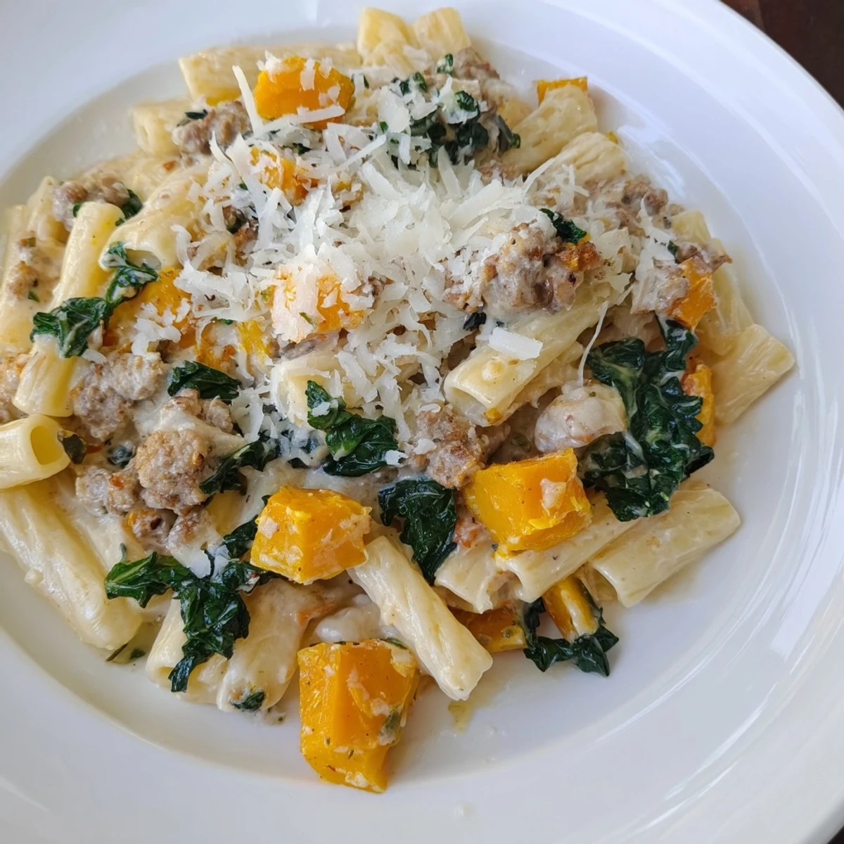 Delicious Creamy Rigatoni: pasta swimming in a rich, creamy sauce with Italian sausage.