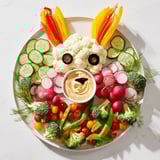 Fresh Bunny Meadow Veggie Board features colorful carrots, tomatoes, and broccoli creating a playful veggie platter.