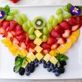 Freshly assembled Butterfly Bloom Fruit Board bursts with vibrant colors, perfect for a healthy and festive snack.