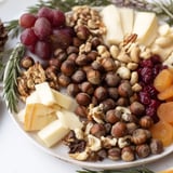Fall flavors abound on this Squirrels Acorn Hoard Platter, featuring dried fruits and fresh rosemary sprigs.