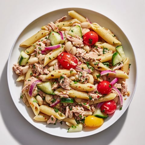 Flaky tuna and creamy white beans star in this vibrant Spicy Tuna Pasta Salad.