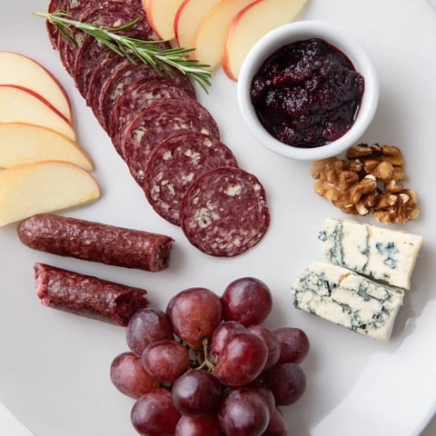 Deer Antler Charcuterie: A beautifully arranged gourmet board featuring venison, cheeses, and wild berry compote.