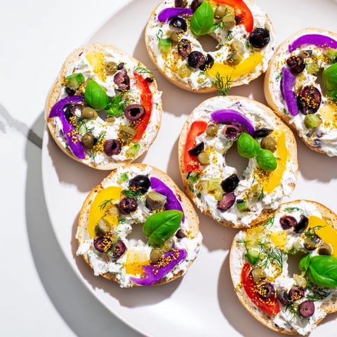 Colorful Olympic Rings Medal Appetizer, featuring bagel "medals" with vibrant cream cheese toppings for a party.