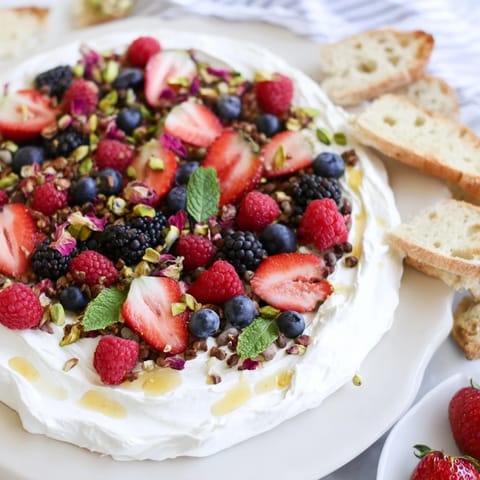 A tempting Butter Board Dessert Version spread with creamy cheese and colorful berry toppings.  