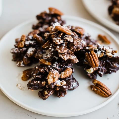 Close-up of rustic Pinecone Chocolate Nut Clusters with shimmering dark chocolate, perfect holiday treat.