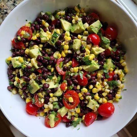 Close-up of a refreshing Southwestern Black Bean and Corn Salad, drizzled with lime-cilantro dressing.