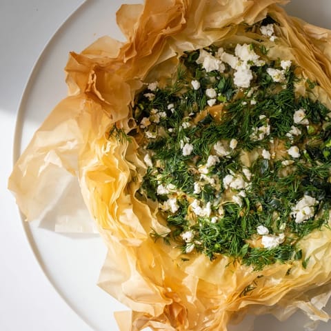 Warm, aromatic steam rises from a freshly baked Greek spanakopita, ready to be enjoyed.
