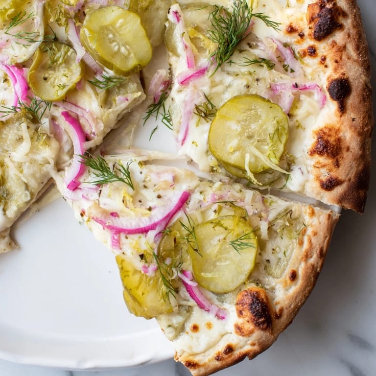 Unique Pickle Pizza with rich crème fraîche and vibrant dill, ideal for adventurous eaters.