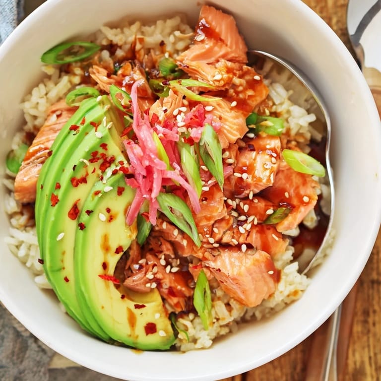 Microwave-steamed Leftover Salmon & Rice Bowl garnished with pickled ginger and scallions.