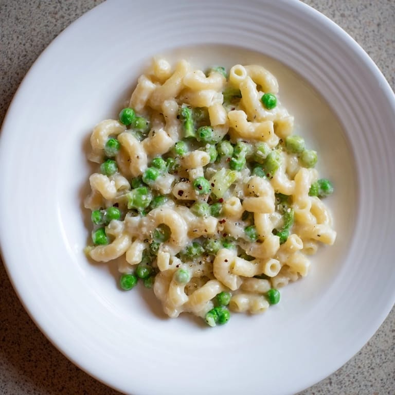 A family-style serving of Macaroni & Peas, perfect for a quick and easy weeknight dinner.