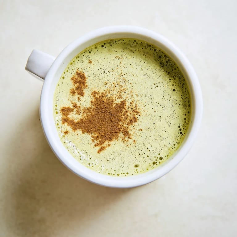 Frothy Cinnamon Maple Oat Milk Matcha Latte, the dairy-free drink is sweetened and looks delicious.