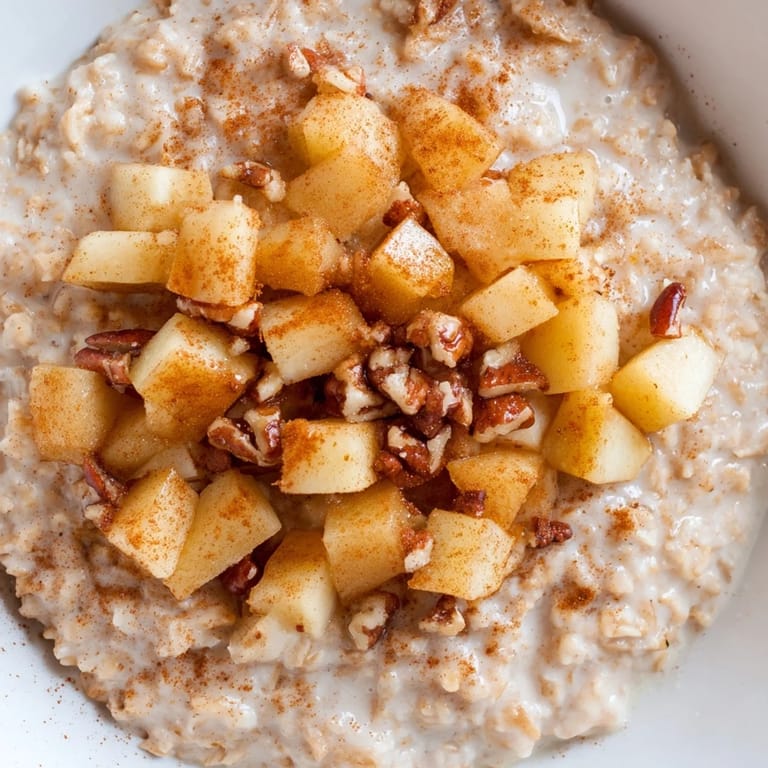 This hearty apple pie oatmeal bowl boasts cinnamon-spiced oats and sweet, tender apple slices.