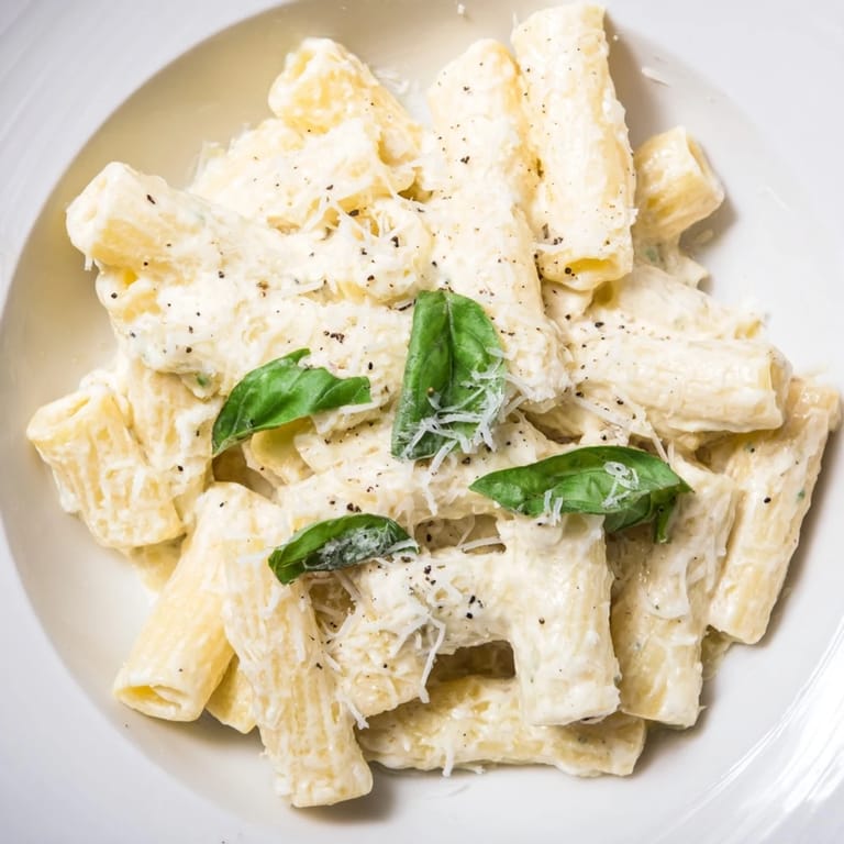 Close up: perfectly textured creamy cottage cheese pasta, with a sprinkle of red pepper flakes.